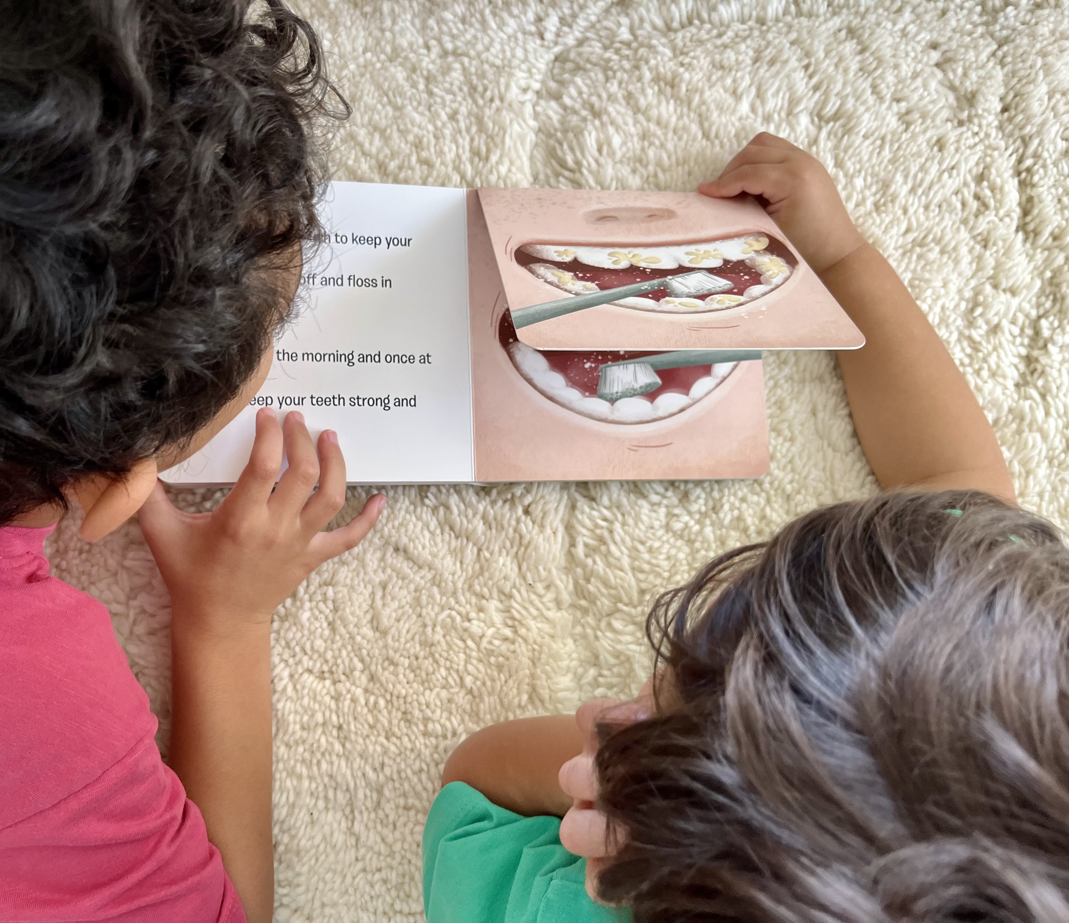 Two children reading Little Doctors Dentistry lift-the-flap book together