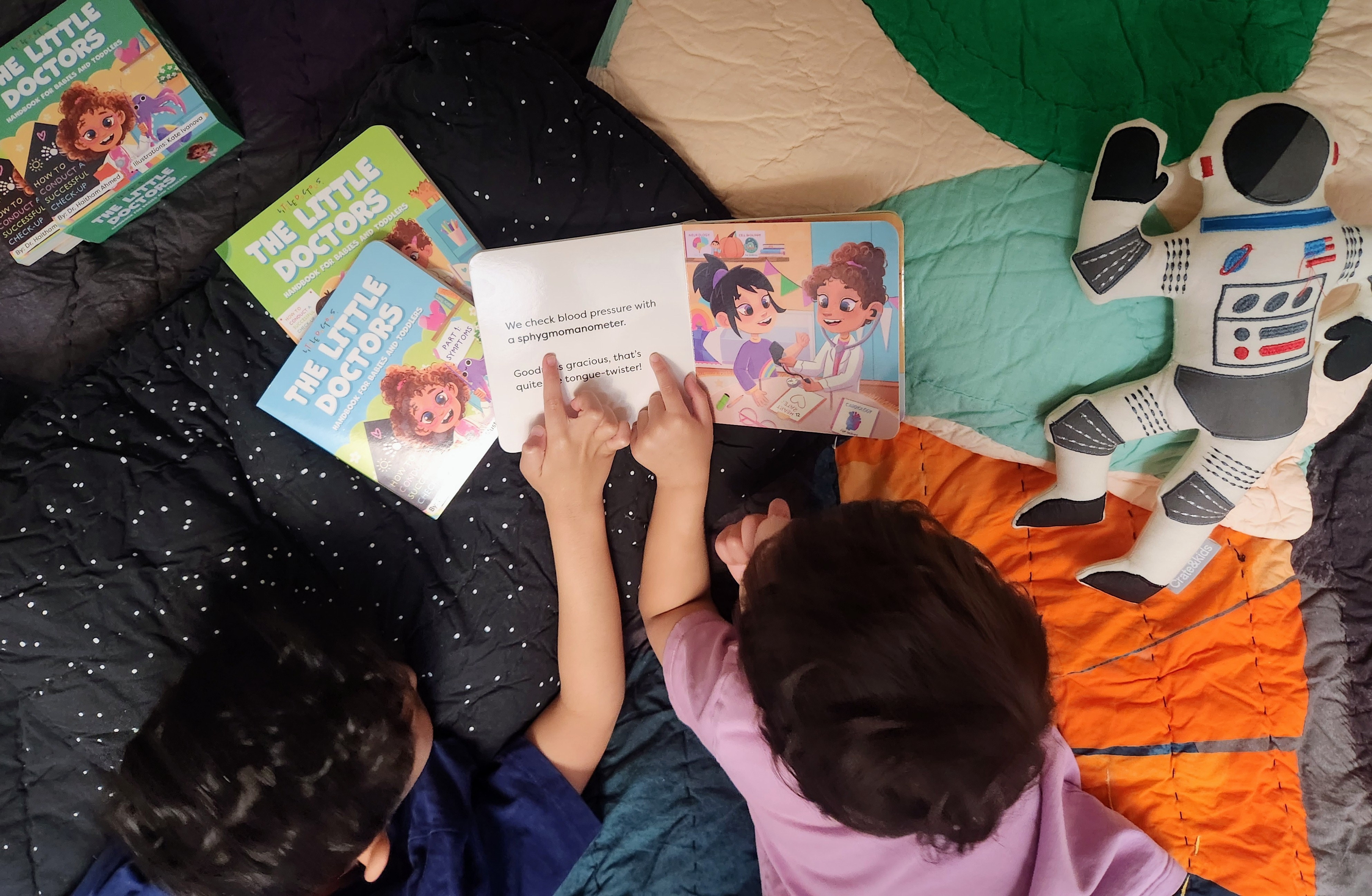 Two children reading Little Doctors together